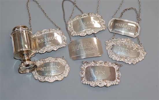 A collection of seven various silver wine and spirit labels and a George III silver pepper pot, by John Emes.